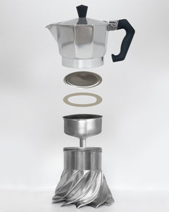 Exploded view of the Turbo Moka 3-cup showing every part in the spare parts kit: top chamber, filter plate, silicone gasket, funnel and boiler